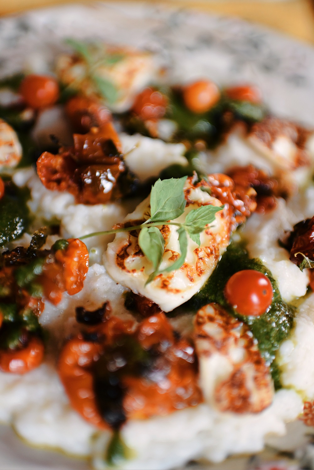 Blistered Tomato Polenta with Mint Pistachio Pesto Recipe: this rustic vegetarian recipe is the perfect way to use fresh mint in a savory dinner dish! #mintpesto #mintrecipe #blisteredtomatopolenta #vegetarianrecipe