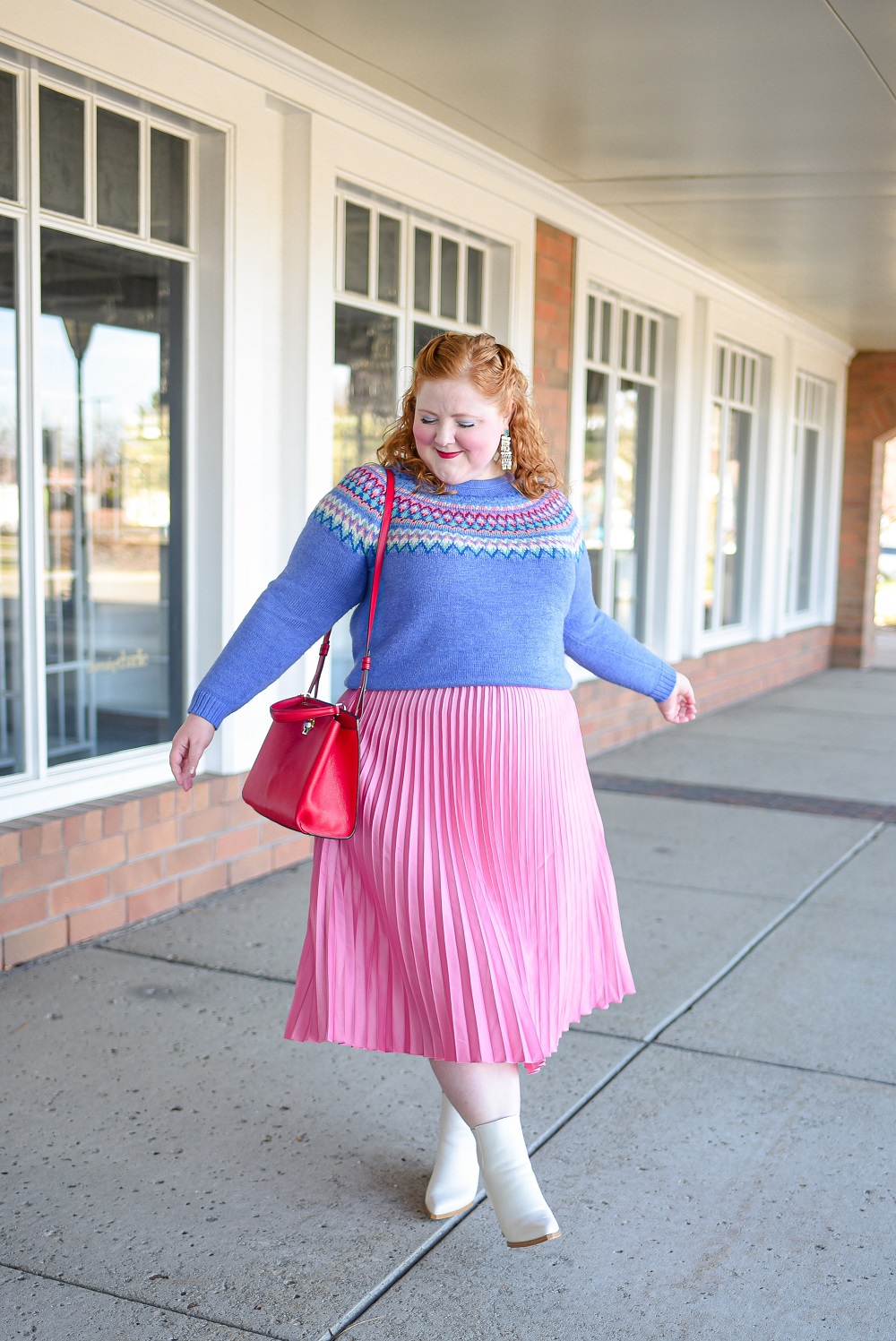 A Festive Holiday Outfit Formula: a plus size outfit featuring a Christopher and Banks fair isle sweater, an H&M pleated skirt, and Kendra Scott earrings. #christopherandbanks #holidayoutfit #christmasoutfit #holidayfashion #holidaystyle #katespadebag #whiteboots