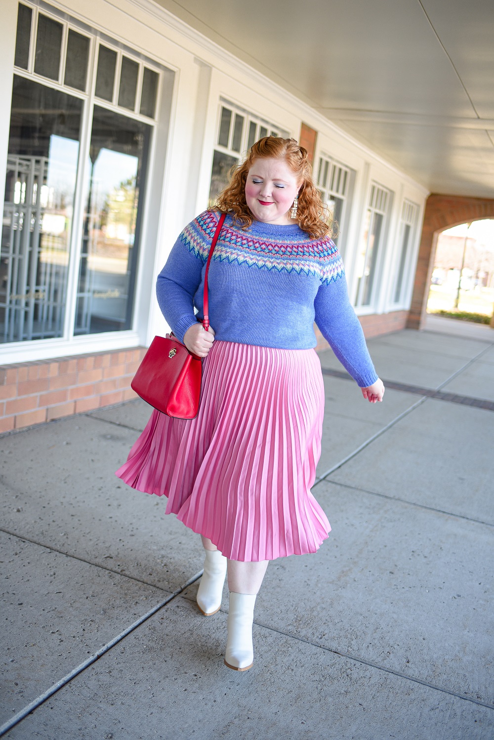 A Festive Holiday Outfit Formula: a plus size outfit featuring a Christopher and Banks fair isle sweater, an H&M pleated skirt, and Kendra Scott earrings. #christopherandbanks #holidayoutfit #christmasoutfit #holidayfashion #holidaystyle #katespadebag #whiteboots