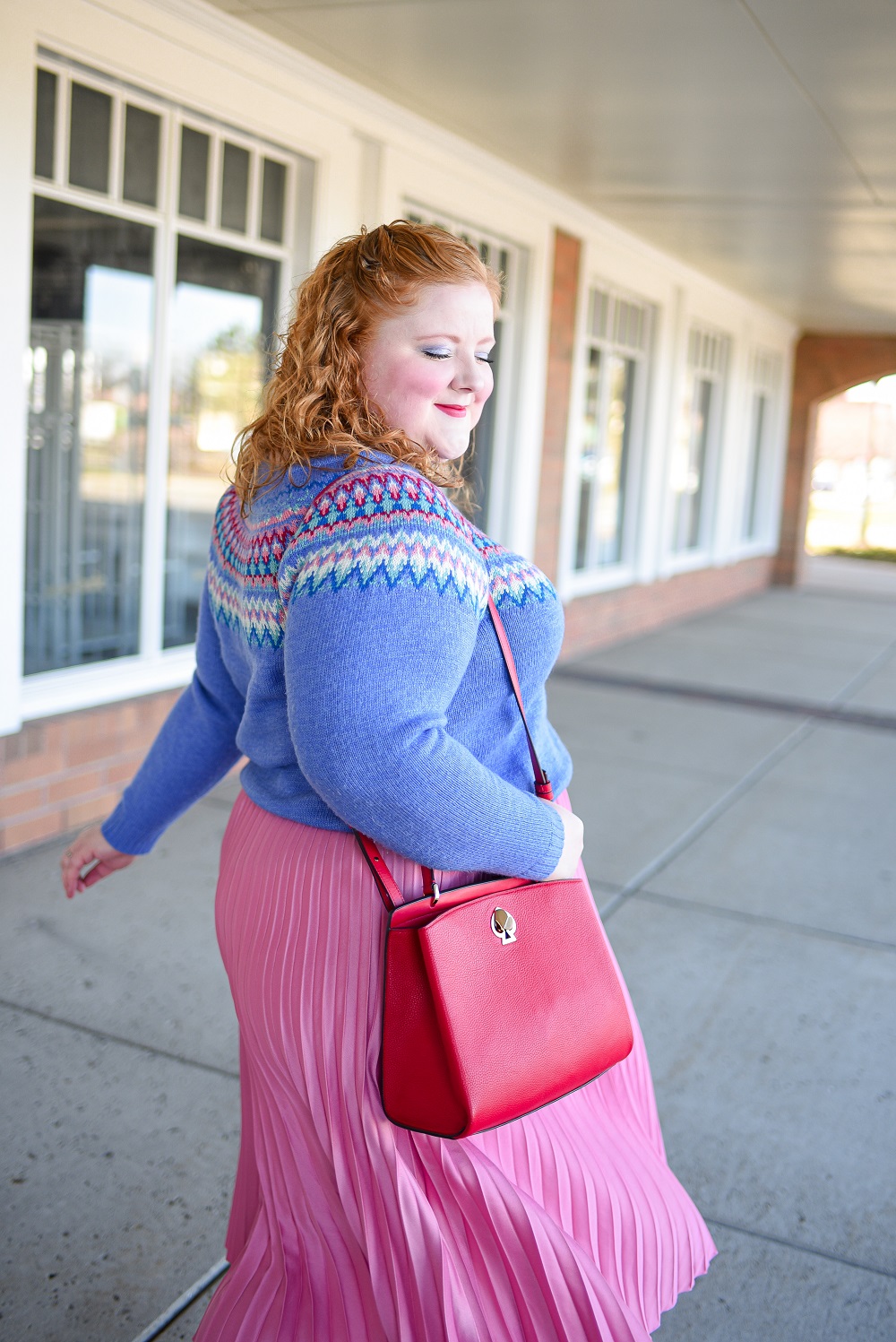 A Festive Holiday Outfit Formula: a plus size outfit featuring a Christopher and Banks fair isle sweater, an H&M pleated skirt, and Kendra Scott earrings. #christopherandbanks #holidayoutfit #christmasoutfit #holidayfashion #holidaystyle #katespadebag #whiteboots