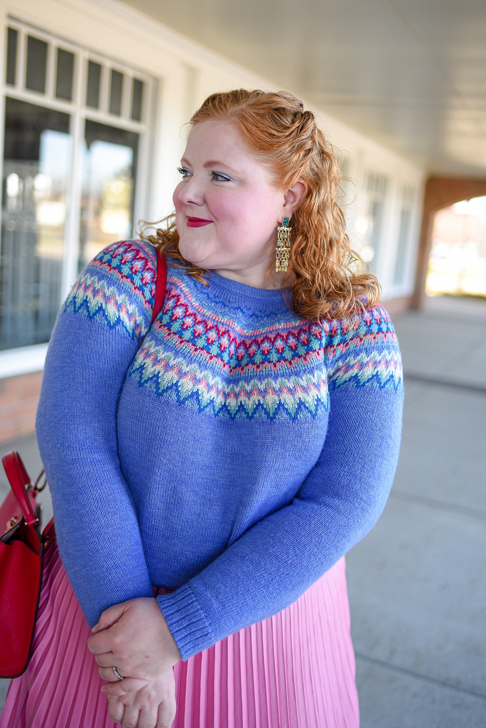 A Festive Holiday Outfit Formula: a plus size outfit featuring a Christopher and Banks fair isle sweater, an H&M pleated skirt, and Kendra Scott earrings. #christopherandbanks #holidayoutfit #christmasoutfit #holidayfashion #holidaystyle #katespadebag #whiteboots