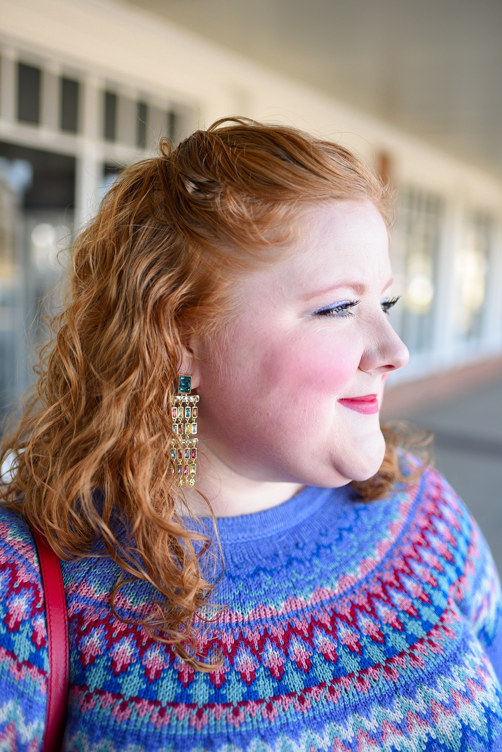 A Festive Holiday Outfit Formula: a plus size outfit featuring a Christopher and Banks fair isle sweater, an H&M pleated skirt, and Kendra Scott earrings. #christopherandbanks #holidayoutfit #christmasoutfit #holidayfashion #holidaystyle #katespadebag #whiteboots