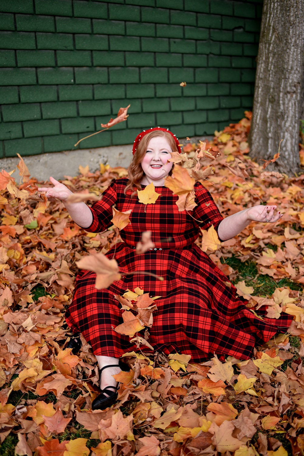 The Perfect Red Plaid Dress: the plus size Devon Swing Dress from Unique Vintage styled for holiday and Christmas with a red pearl beret and black T-straps. #uniquevintange #plaiddress #redplaiddress #redberet #pearlberet #fallleavesphotoshoot #fallleaves #autumnleaves