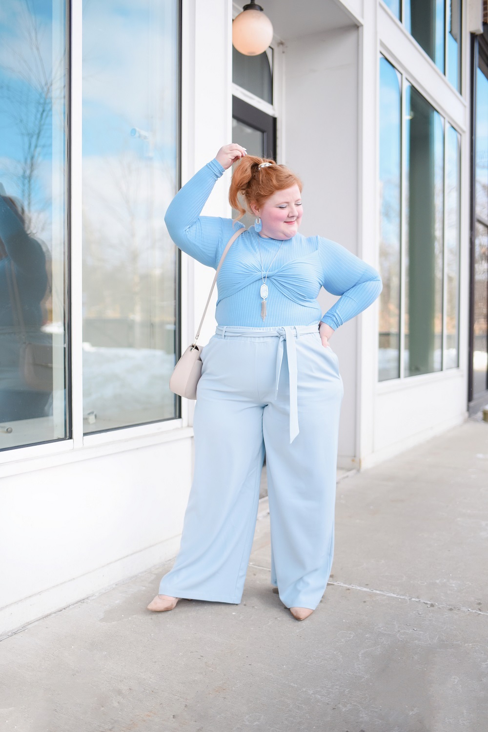 A Monochrome Blue Outfit: ELOQUII plus size top and wide leg trousers, Kendra Scott jewelry, Kate Spade bag, and Marc Fisher nude pumps. #blueoutfit #monochromeblueoutfit #outfit #eloquii 