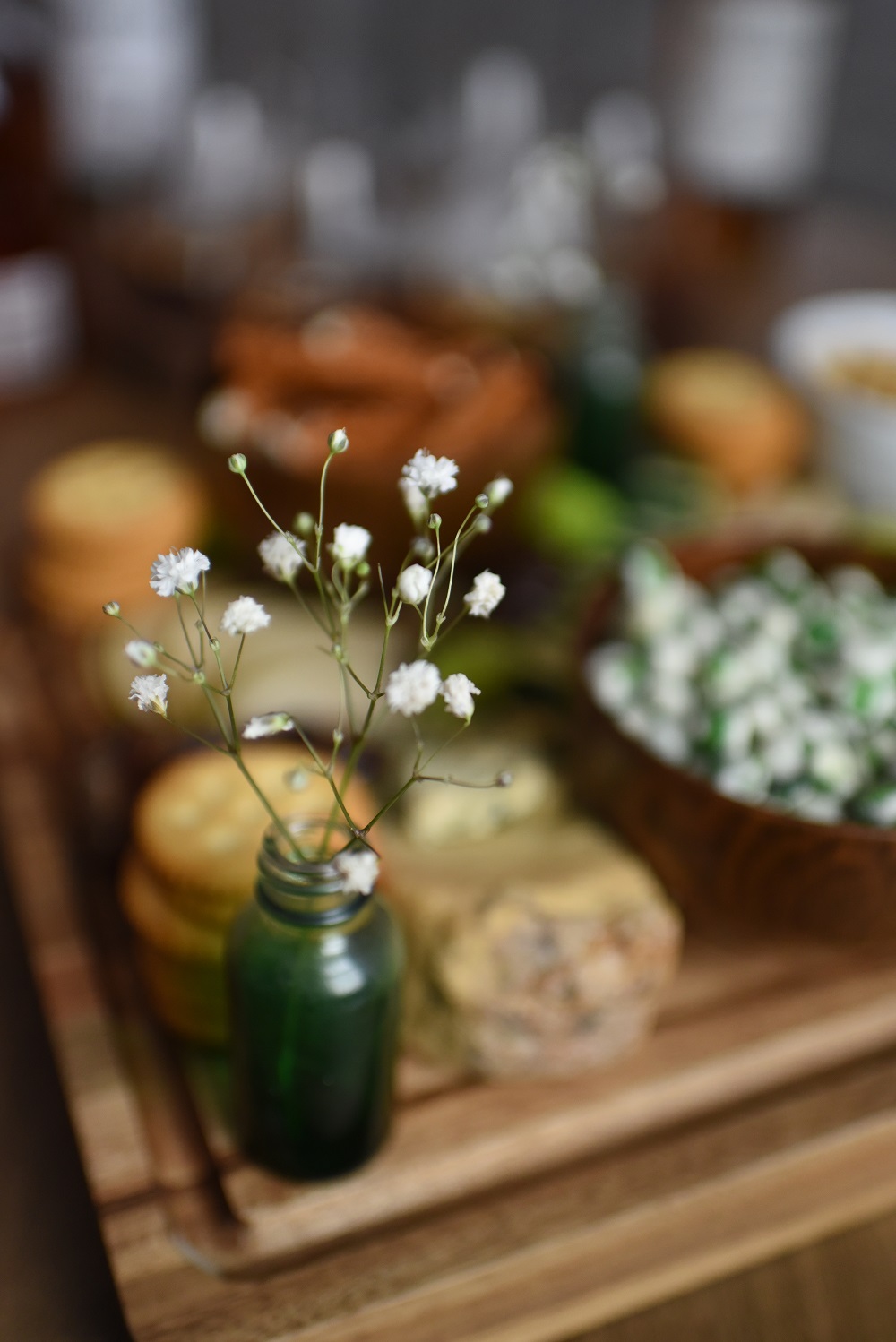 A St. Patrick's Day Cheese Board featuring Irish cheeses, salted pretzels, crackers, sliced pear, peanuts, wasabi peas, dates, and chocolates. #stpatricksdaycheeseboard #stpatricksdaysnacks #stpatricksdayrecipe