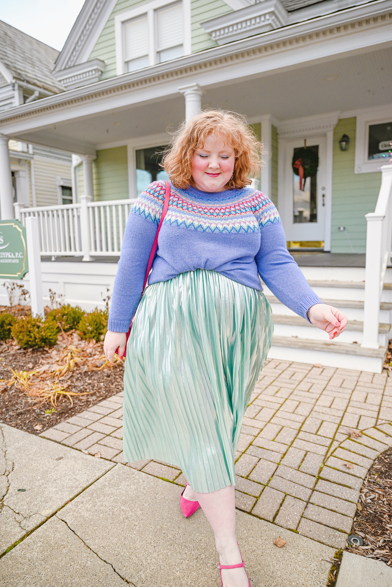 A Colorful Whoville Inspired Holiday Outfit: style a fair isle Christmas sweater with a metallic pleated skirt, jewel earrings, and hot pink mules.
