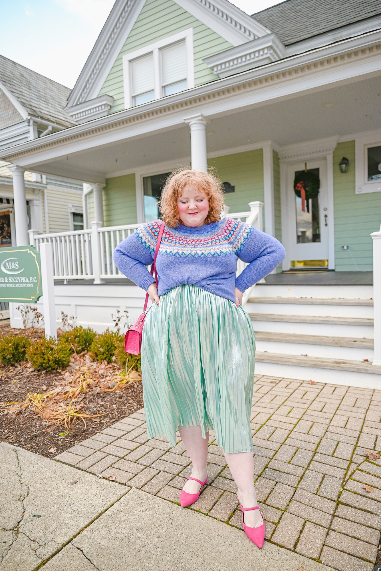 A Colorful Whoville Inspired Holiday Outfit: style a fair isle Christmas sweater with a metallic pleated skirt, jewel earrings, and hot pink mules.