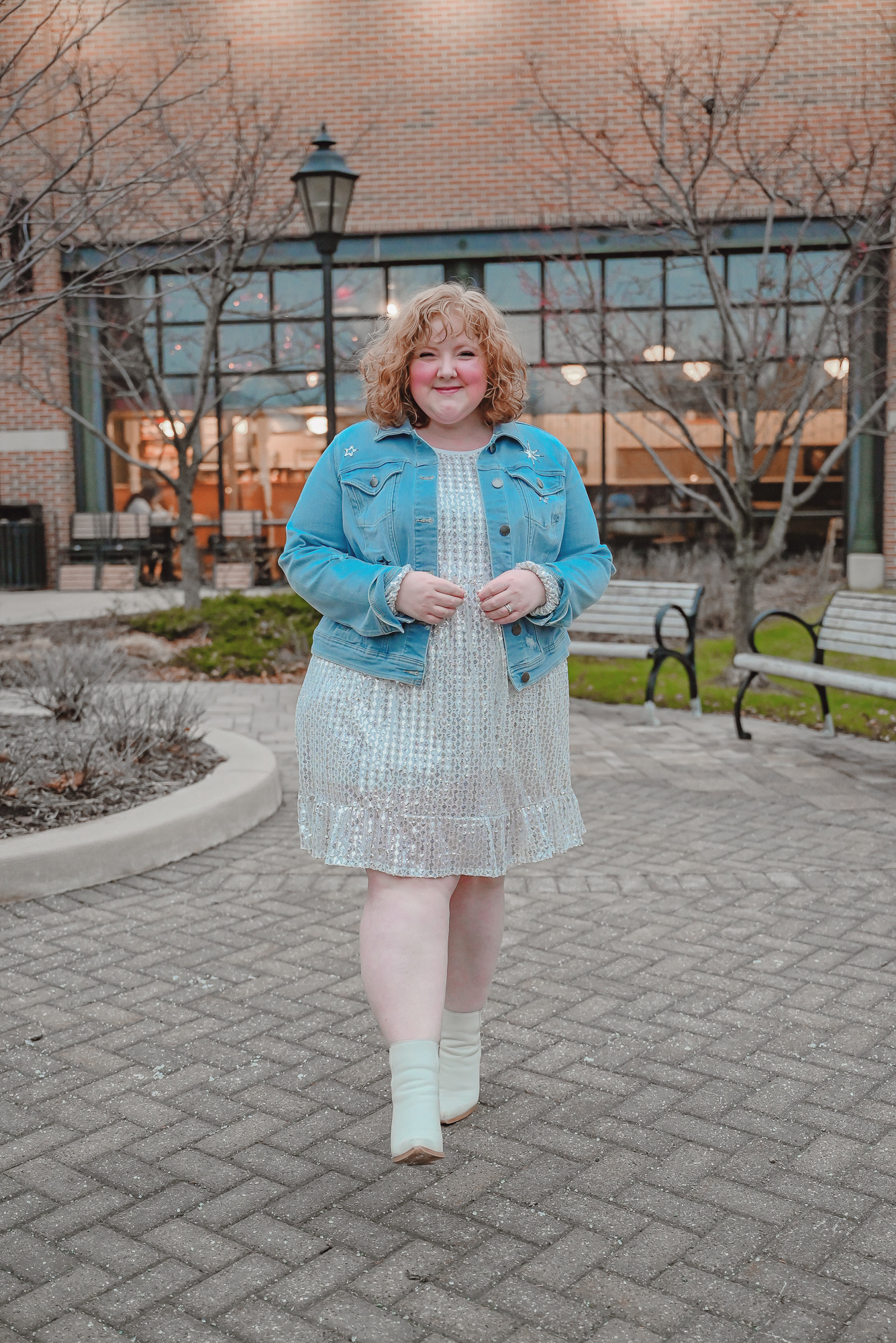 A Holiday Party Outfit Idea: style a sequin party dress with a denim jacket, statement earrings, and ankle boots.