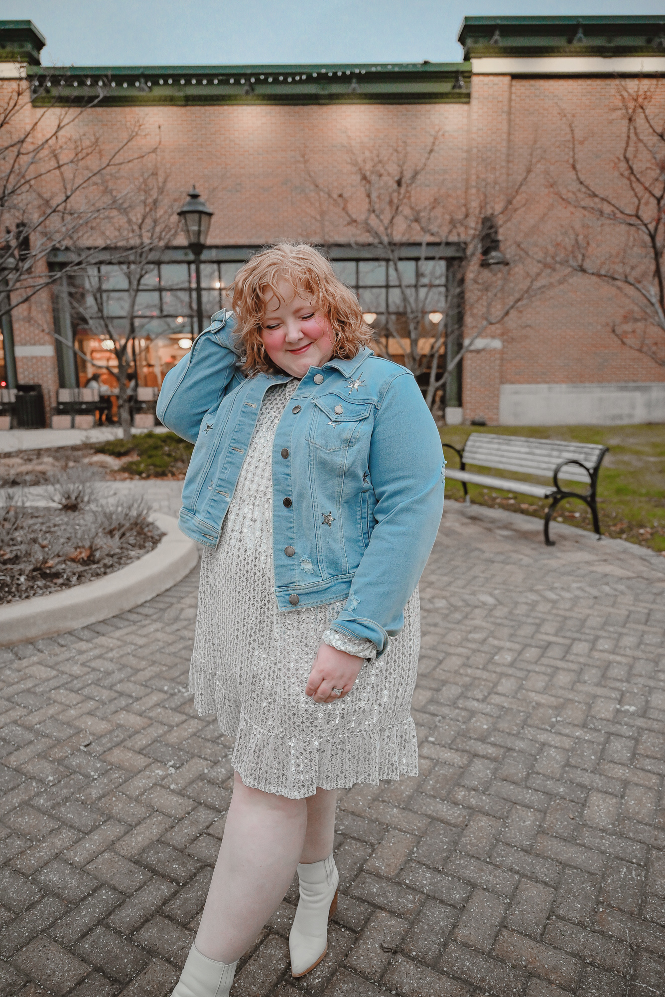 A Holiday Party Outfit Idea: style a sequin party dress with a denim jacket, statement earrings, and ankle boots.