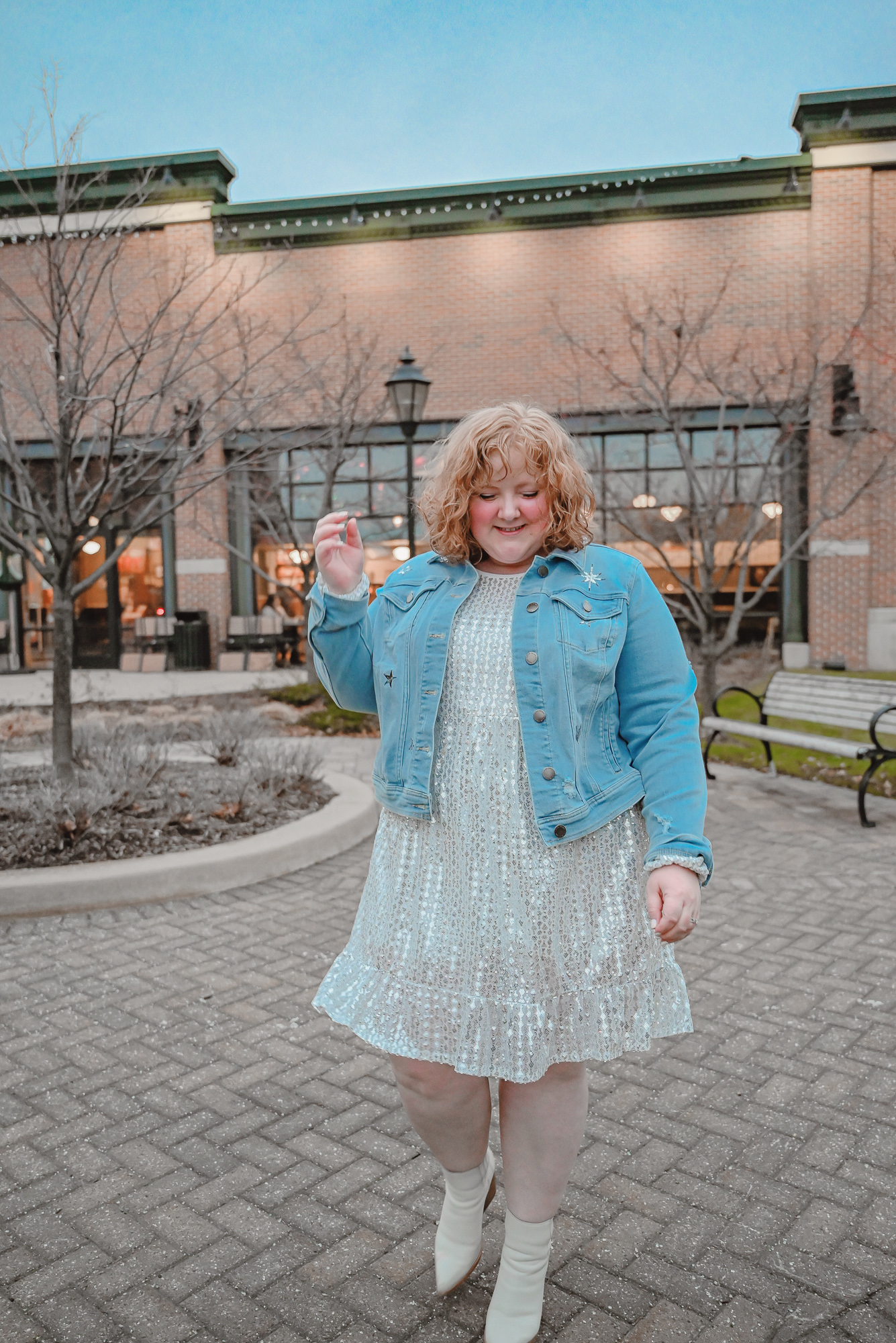 A Holiday Party Outfit Idea: style a sequin party dress with a denim jacket, statement earrings, and ankle boots.