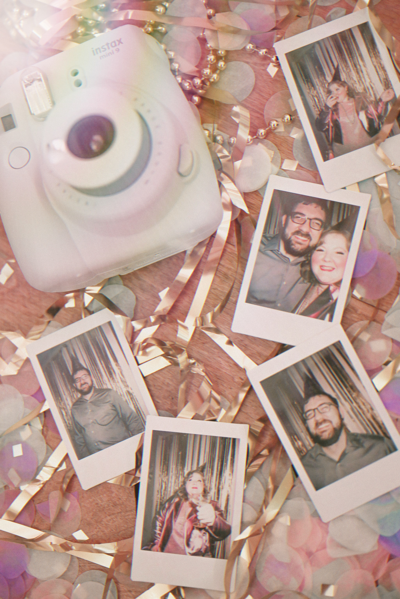 A Pink NYE Photoshoot | Celebrate New Year's Eve at home with a DIY backdrop using tinsel curtains, confetti, balloons, and party beads.