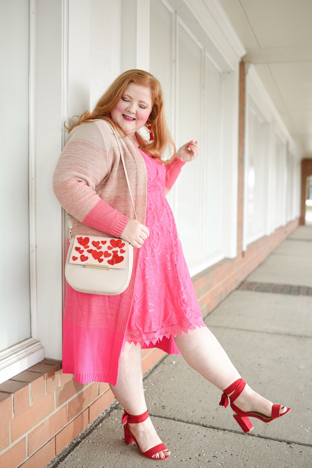 Shop Valentine's Day at Torrid | A plus size pink and red VDay outfit with a hot pink dress, pink duster cardigan, and red wide fit heels.